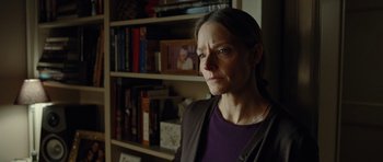 Movie still from “Carnage” (2011), directed by Roman Polanski – A woman standing in front of a book shelf; Close Up shot, Over the shoulder angle