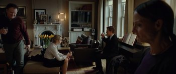 Movie still from “Carnage” (2011), directed by Roman Polanski – A man and a woman sitting in a living room; Wide shot, Over the shoulder angle