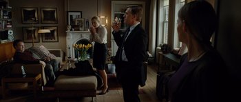 Movie still from “Carnage” (2011), directed by Roman Polanski – A man and a woman standing in a living room drinking wine; Medium shot, Over the shoulder angle