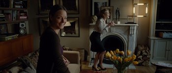 Movie still from “Carnage” (2011), directed by Roman Polanski – Two women in a living room playing a video game; Wide shot, Over the shoulder angle