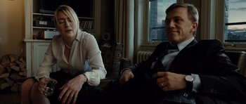 Movie still from “Carnage” (2011), directed by Roman Polanski – A man and a woman sitting in a living room; Medium shot, Over the shoulder angle
