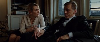 Movie still from “Carnage” (2011), directed by Roman Polanski – A man and a woman sitting on a couch in front of a window; Medium shot, Over the shoulder angle