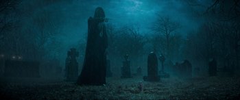 Movie still from “Spirited” (2022), directed by Sean Anders – A man that is standing in the grass; Wide shot, Over the shoulder angle