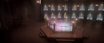 Movie still from “Spirited” (2022), directed by Sean Anders – A room filled with lights and statues on the walls; Extreme Wide shot, High angle