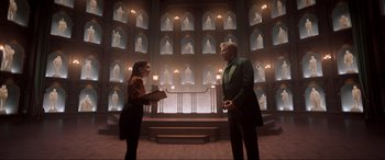 Movie still from “Spirited” (2022), directed by Sean Anders – A man and a woman standing next to each other in a room; Wide shot, Low angle