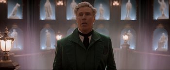 Movie still from “Spirited” (2022), directed by Sean Anders – A man in a green suit and a black tie; Medium shot, Low angle