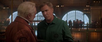 Movie still from “Spirited” (2022), directed by Sean Anders – A man in a green shirt talking to another man in a green shirt; Medium shot, Over the shoulder angle