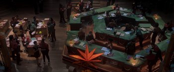 Movie still from “Spirited” (2022), directed by Sean Anders – A group of people sitting at tables with papers on them; Extreme Wide shot, High angle