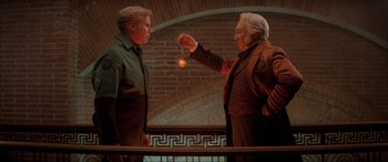 Movie still from “Spirited” (2022), directed by Sean Anders – Two people standing next to each other holding a light bulb; Medium shot, Low angle