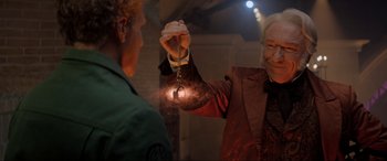 Movie still from “Spirited” (2022), directed by Sean Anders – A man and a woman holding a key chain in their hands; Close Up shot, Over the shoulder angle