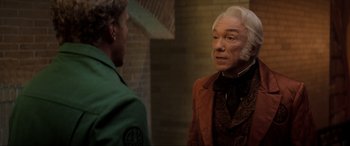 Movie still from “Spirited” (2022), directed by Sean Anders – A man in a green shirt and an older man in a brown jacket; Close Up shot, Over the shoulder angle