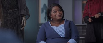 Movie still from “Spirited” (2022), directed by Sean Anders – A woman sitting in a chair looking up at the sky; Medium shot, Over the shoulder angle