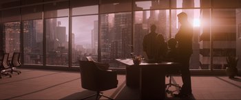 Movie still from “Spirited” (2022), directed by Sean Anders – A group of people sitting at a table in a room; Extreme Wide shot, Over the shoulder angle