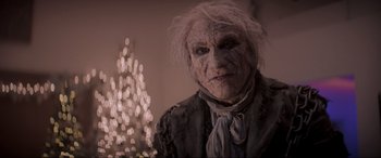 Movie still from “Spirited” (2022), directed by Sean Anders – An old man with white hair is posing for a picture; Close Up shot, Low angle