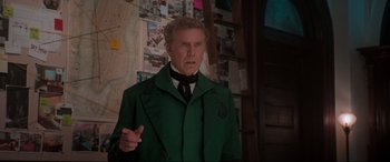 Movie still from “Spirited” (2022), directed by Sean Anders – A man in a green jacket and a black tie; Medium shot, Over the shoulder angle