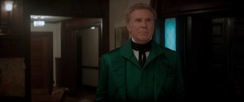 Movie still from “Spirited” (2022), directed by Sean Anders – A man in a green jacket and a black tie; Medium shot, Over the shoulder angle