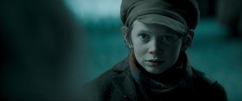 Movie still from “Spirited” (2022), directed by Sean Anders – A young boy wearing a hat and a coat; Close Up shot, Over the shoulder angle