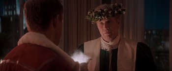 Movie still from “Spirited” (2022), directed by Sean Anders – A man wearing a crown and holding a light; Close Up shot, Over the shoulder angle