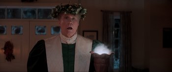 Movie still from “Spirited” (2022), directed by Sean Anders – A man wearing a crown and a white robe; Medium shot, Over the shoulder angle