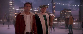 Movie still from “Spirited” (2022), directed by Sean Anders – A couple of men standing next to each other; Medium shot, Over the shoulder angle