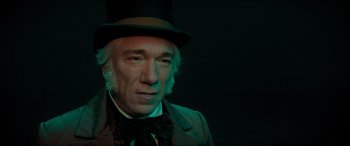 Movie still from “Spirited” (2022), directed by Sean Anders – A person wearing a top hat; Close Up shot, High angle