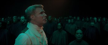 Movie still from “Spirited” (2022), directed by Sean Anders – A group of people standing in a dark room; Medium shot, High angle