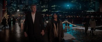 Movie still from “Spirited” (2022), directed by Sean Anders – A man and a woman holding hands while standing next to each other; Medium shot, Over the shoulder angle