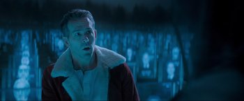 Movie still from “Spirited” (2022), directed by Sean Anders – A man in a red jacket is looking up at the sky; Close Up shot, Over the shoulder angle