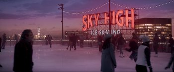 Movie still from “Spirited” (2022), directed by Sean Anders – People skating on the ice at the sky high ice - skating rink; Extreme Wide shot, Low angle