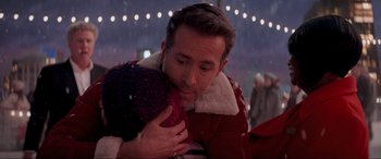 Movie still from “Spirited” (2022), directed by Sean Anders – A man holding a stuffed animal in his arms; Close Up shot, Over the shoulder angle