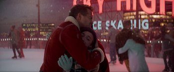 Movie still from “Spirited” (2022), directed by Sean Anders – A man and a woman hugging in front of a neon sign; Close Up shot, Over the shoulder angle