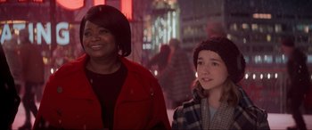 Movie still from “Spirited” (2022), directed by Sean Anders – Two women standing next to each other on a city street; Medium shot, Over the shoulder angle