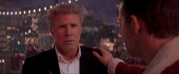 Movie still from “Spirited” (2022), directed by Sean Anders – A man in a business suit is being interviewed by a woman; Close Up shot, Over the shoulder angle