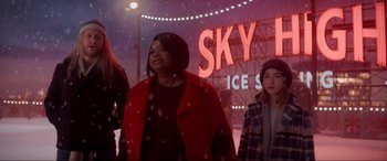 Movie still from “Spirited” (2022), directed by Sean Anders – A group of people standing in the snow at night; Medium shot, Low angle