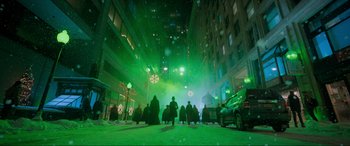 Movie still from “Spirited” (2022), directed by Sean Anders – A group of people standing on a street at night; Extreme Wide shot, Low angle