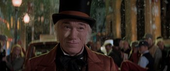 Movie still from “Spirited” (2022), directed by Sean Anders – A person wearing a top hat; Close Up shot, Over the shoulder angle