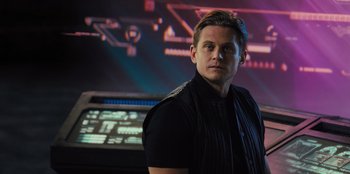 Movie still from “Spy Kids: Armageddon” (2023), directed by Robert Rodriguez – A man standing in front of a computer screen; Close Up shot, Over the shoulder angle