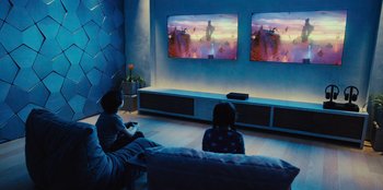 Movie still from “Spy Kids: Armageddon” (2023), directed by Robert Rodriguez – Two children are sitting in front of a television; Wide shot, High angle