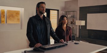 Movie still from “Spy Kids: Armageddon” (2023), directed by Robert Rodriguez – A man and a woman standing in front of a computer keyboard; Medium shot, Over the shoulder angle