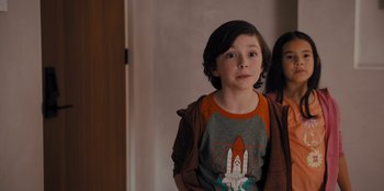 Movie still from “Spy Kids: Armageddon” (2023), directed by Robert Rodriguez – A young boy standing in front of a mirror; Medium shot, Over the shoulder angle