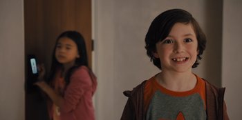 Movie still from “Spy Kids: Armageddon” (2023), directed by Robert Rodriguez – A young boy and a young girl standing next to each other; Close Up shot, Over the shoulder angle