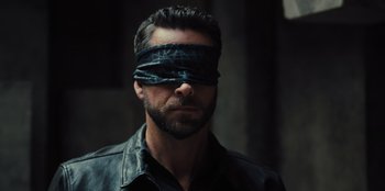 Movie still from “Spy Kids: Armageddon” (2023), directed by Robert Rodriguez – A man with a blindfold on his face; Close Up shot, Over the shoulder angle
