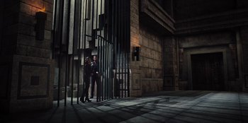 Movie still from “Spy Kids: Armageddon” (2023), directed by Robert Rodriguez – A man and a woman standing next to a metal gate; Wide shot, Low angle