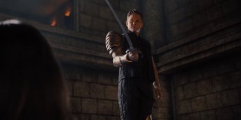 Movie still from “Spy Kids: Armageddon” (2023), directed by Robert Rodriguez – A man holding a sword in his hand; Medium shot, Low angle