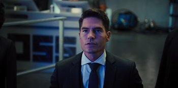 Movie still from “Spy Kids: Armageddon” (2023), directed by Robert Rodriguez – A person wearing a suit and tie; Close Up shot, Over the shoulder angle