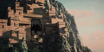 Movie still from “Spy Kids: Armageddon” (2023), directed by Robert Rodriguez – An old castle on a mountain side with a sky background; Extreme Wide shot, Low angle