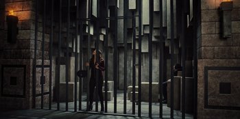 Movie still from “Spy Kids: Armageddon” (2023), directed by Robert Rodriguez – A woman standing in front of a metal gate; Wide shot, Low angle