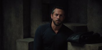 Movie still from “Spy Kids: Armageddon” (2023), directed by Robert Rodriguez – A man in a black shirt is looking at the camera; Close Up shot, Over the shoulder angle