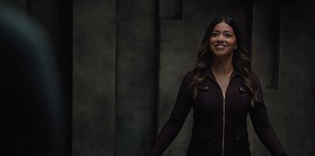 Movie still from “Spy Kids: Armageddon” (2023), directed by Robert Rodriguez – A woman in a black jacket smiling for the camera; Medium shot, Low angle