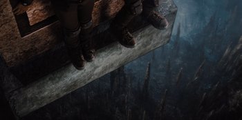 Movie still from “Spy Kids: Armageddon” (2023), directed by Robert Rodriguez – A pair of feet standing on top of a ledge; Wide shot, Overhead angle